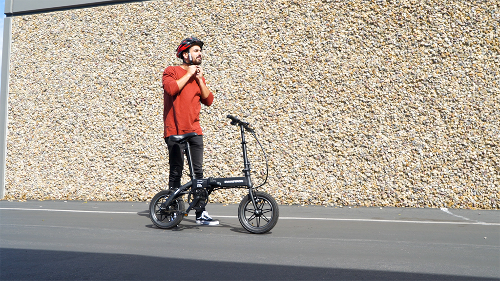 Guy tightening his helmet before riding his EB5 Pro eBike