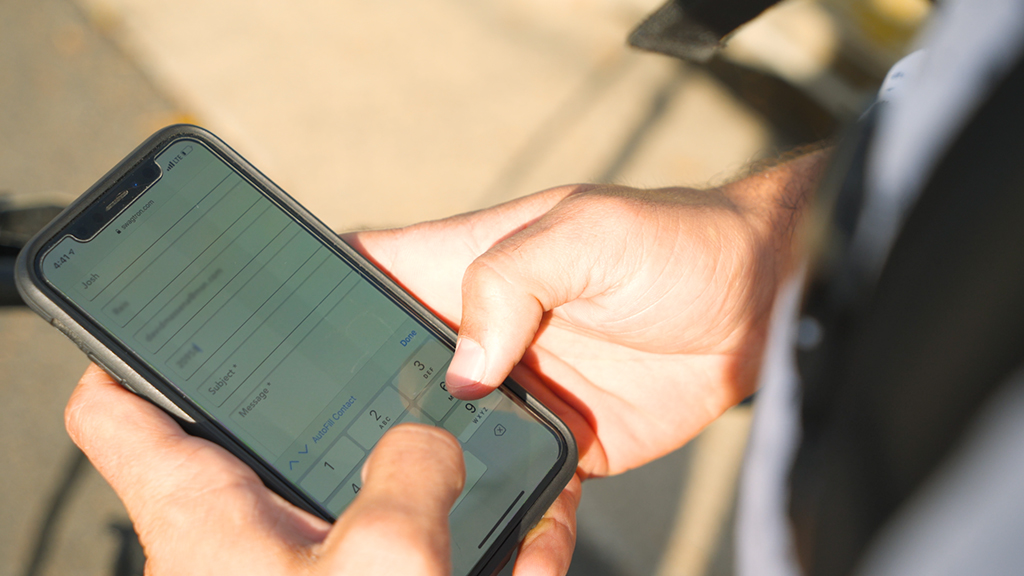 Close-up of EB5 Pro eBike owner using his smartphone to contact SWAGTRON support