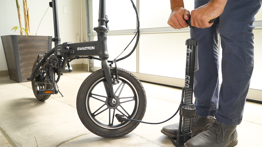 Guy inflating the front tire of the EB5 Pro