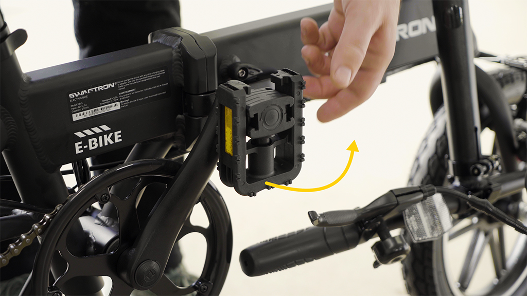 Close-up of guy folding up the EB5 Pro eBike pedals