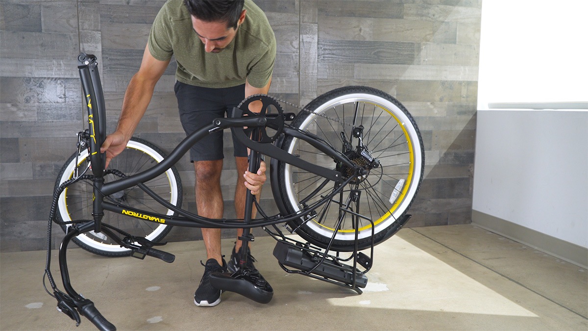 Close-up of man flipping over the EB11 to better assemble the front wheel and fender