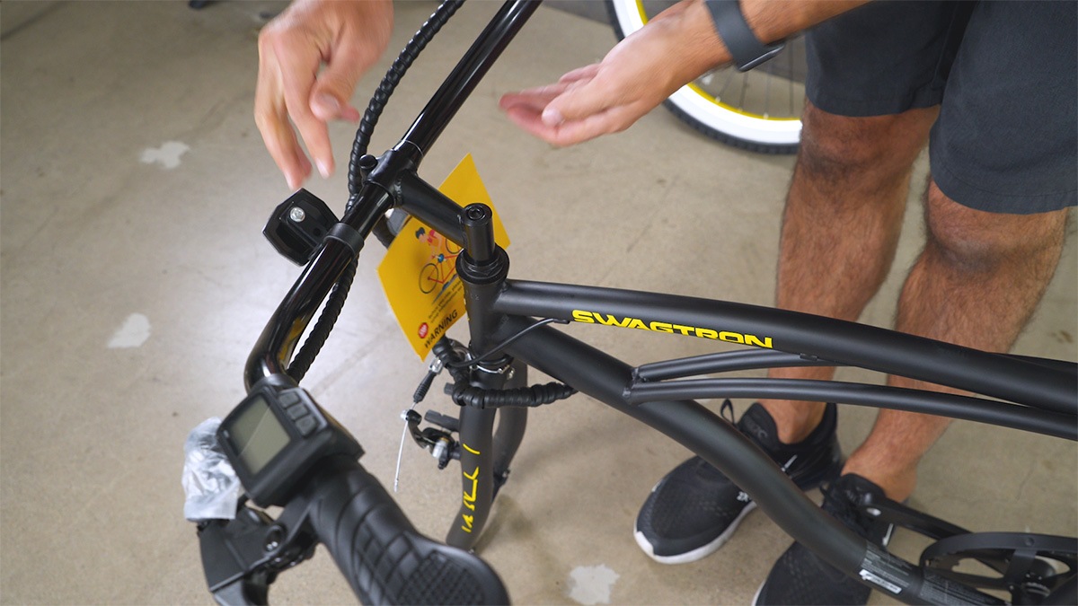 Close-up of man inserting the handlebar into the EB11